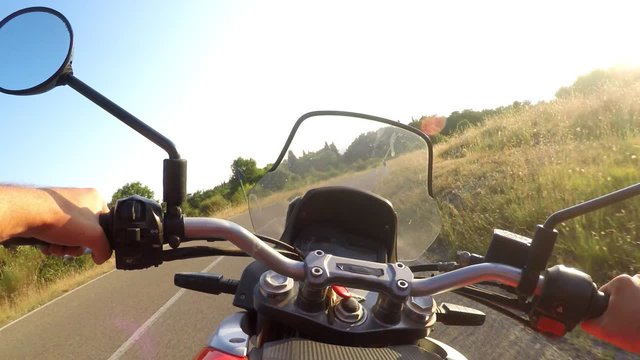 Man driving motorbike on sunset. POV, Original point of View