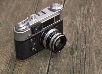 retro the camera on an old wooden table