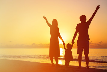 Fototapeta premium happy family with kid having fun on sunset beach
