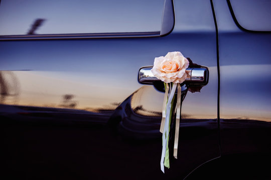 Closeup image of wedding car decoration with flower at sunset 