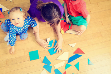 teacher and kids playing with geometric shapes