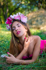 Pretty young lady with long hair wearing wreath 