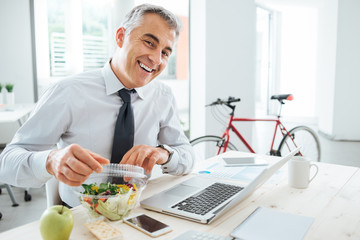 Businessman opening his salad pack