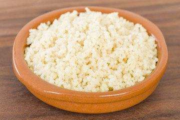 Couscous - Moroccan lemon couscous in a terracotta bowl.
