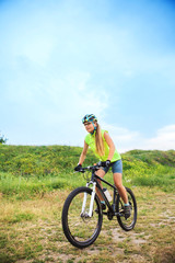 Fototapeta na wymiar Young girl riding bicycle outside. Healthy Lifestyle.