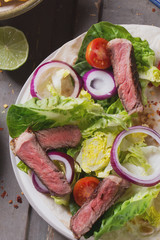 Mexican tortillas with green fresh salad filling, beef, onions, tomatoes with gucamole and tortilla chips on te vintage board