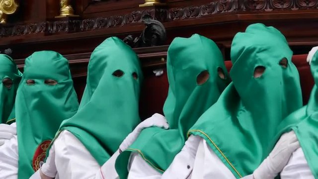  Easter procession in Almu&ntilde;ecar, throne of San Juan Evangelista, with green hoods  
