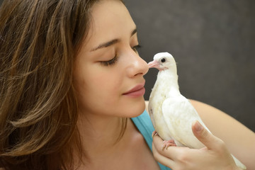 Young woman helping rescue a baby pigeon.