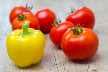 Vegetables tomatoes and pepper on wooden background