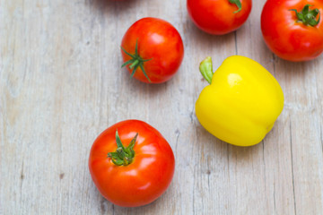Vegetables tomatoes and pepper on wooden background