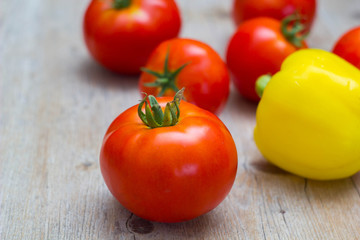 Vegetables tomatoes and pepper on wooden background