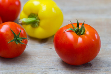 Vegetables tomatoes and pepper on wooden background