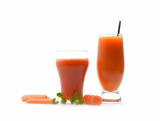 Carrot juice and slices of carrot on white