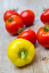 Vegetables tomatoes and pepper on wooden background