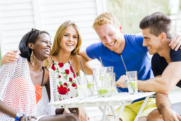 Happy young people laughing a being happy at a table