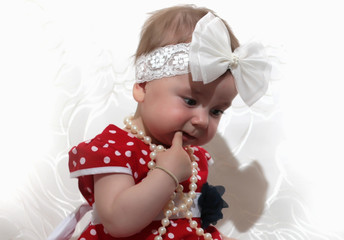 little girl in a red dress and beads