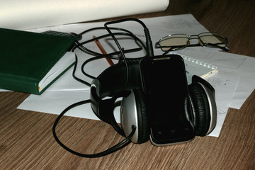 documents headphones and the phone on the table