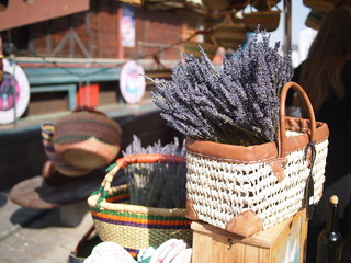 Wicker basket full of lavender flowers on an outdoor flea market. 