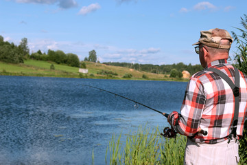 Fisherman with spinning on the water
