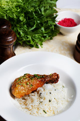 chicken with rice and pesto on a plate still life leg