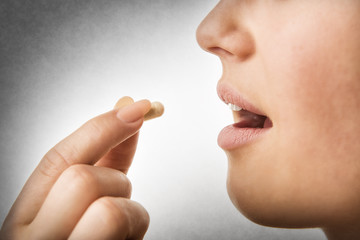 closeup taking pill