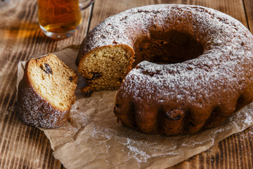 bake ring cake with icing sugar sliced and raisins