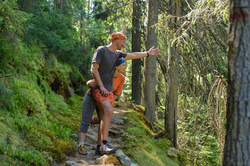 Hiker's couple in pine forest