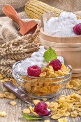 cornflakes with raspberries and domestic sour cream on the table