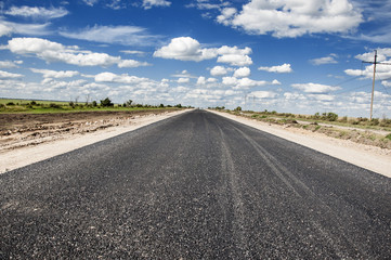 Perspective of asphalt road with blue sky.