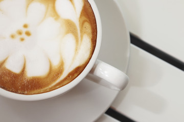 Hot mocha coffee decorated on white background, latte art.