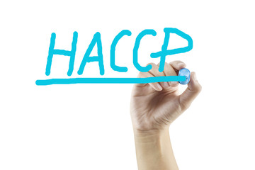 Fototapeta premium Women hand writing HACCP concept (Hazard Analysis of Critical Control Points) for used in manufacturing.