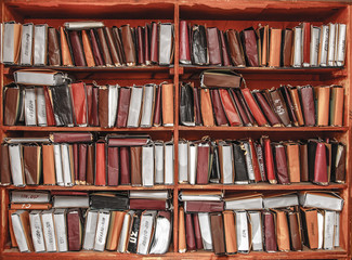 Paper documents stacked on shelf
