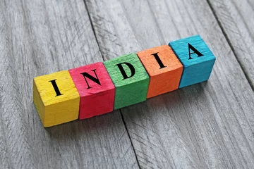 Selbstklebende Fototapeten word India on colorful wooden cubes © chrupka