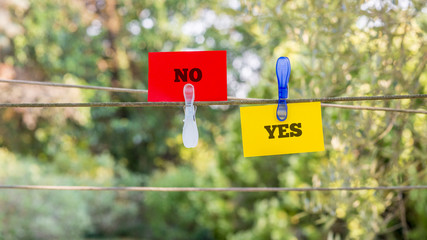 Paper with Yes and No Texts Clipped on a String
