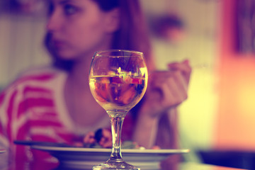 glass of white wine in a restaurant on a background of a person