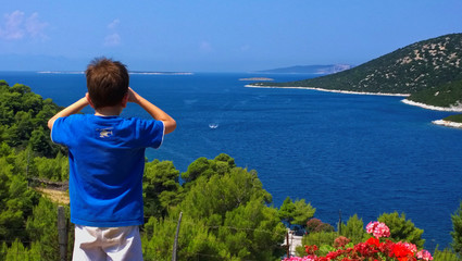 Boy watching the sea from above