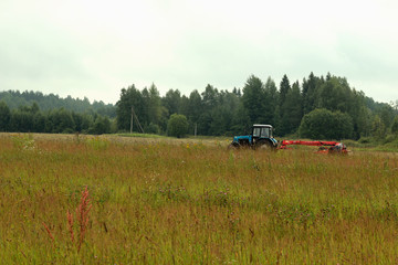 meadow background field tractor mowing