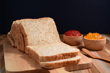 slices bread with jam on wooden table