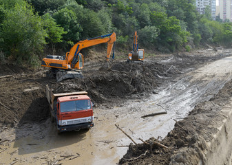 cleaning road by landslide excavator