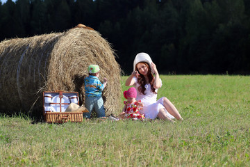 Naklejka na ściany i meble mother with twins in field