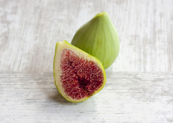 Green figs on a white wooden table