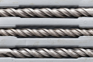 Drill bits on concrete background
