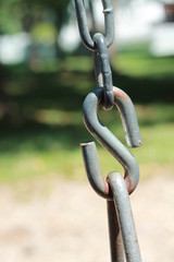 Old gray heavy chain links on playground