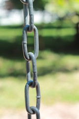 Old gray heavy chain links on playground