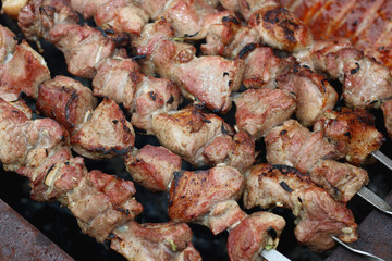meat skewers on the barbecue coals