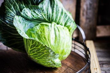 Raw cabbage on wooden background
