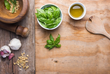 Making pasta with pesto with the original recipe of Genova. Wooden background and accessories communicate the sense of Italy.