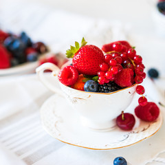 Mix of fresh berries in a cup of tea