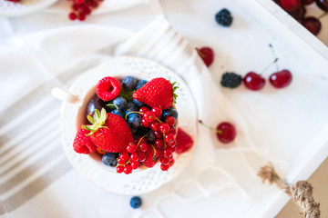 Mix of fresh berries in a cup of tea