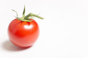 Beautiful fresh tomatoes on a light wooden surface